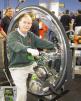 Click Here to see larger photo of Larry Carley on gas-powered unicycle at PRI show